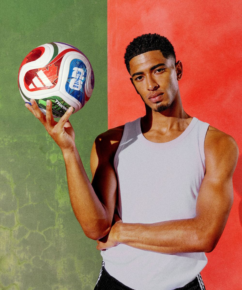 Jude Bellingham holding a Trionda ball with a green and red background