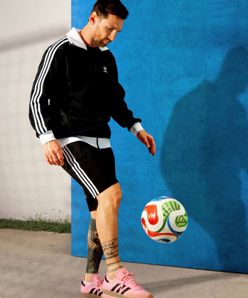 Lionel Messi in adidas tracksuit kicking a Trionda soccer ball