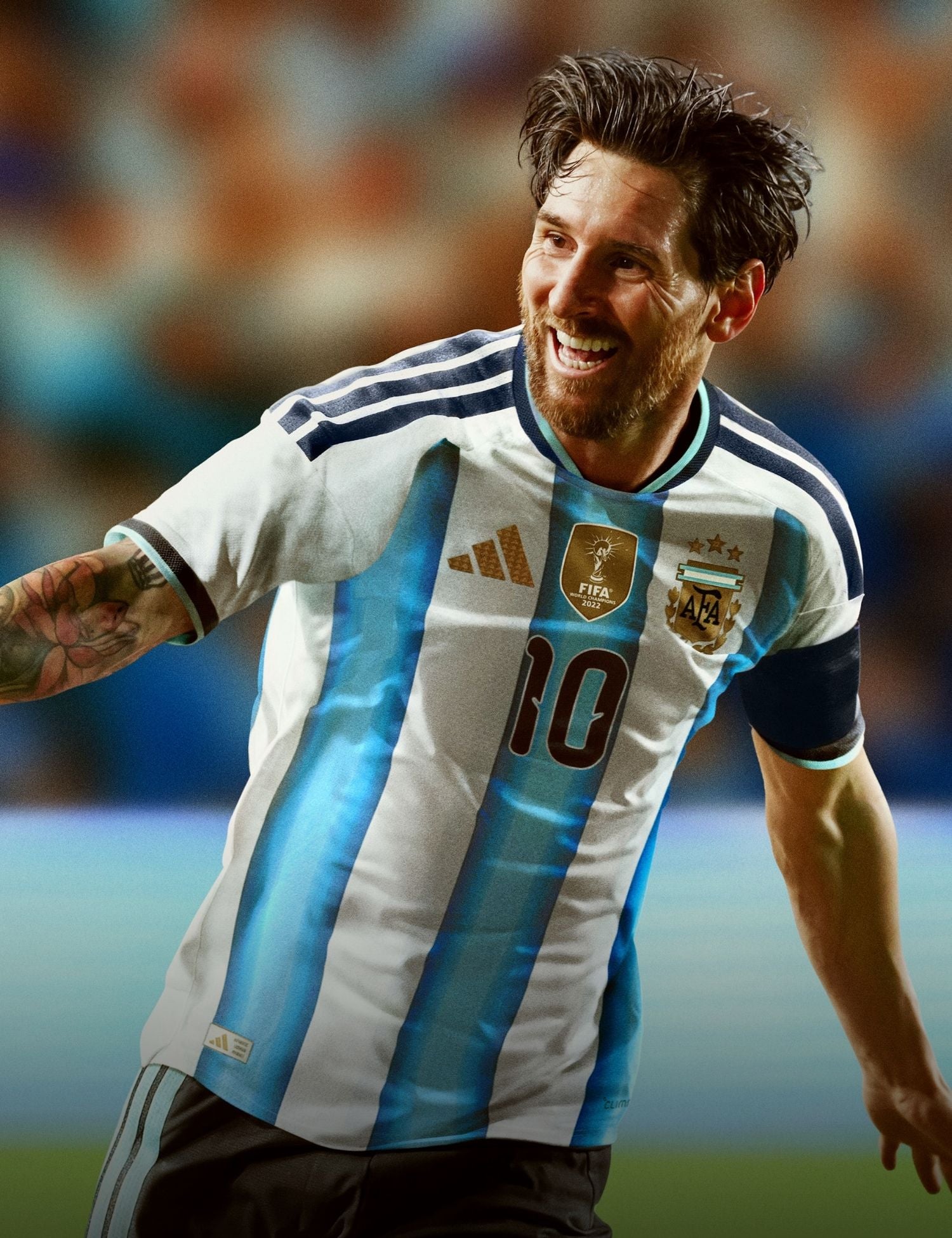 Soccer player in an Argentina jersey with a blurred crowd in the background