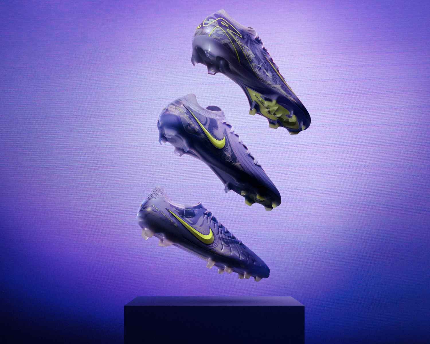Nike United Pack vertical display featuring Mercurial, Phantom, and Tiempo soccer cleats in purple and Volt colorway, designed by women athletes